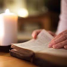 Bible with candle